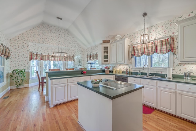 kitchen with white cabinetry, sink, and hanging light fixtures