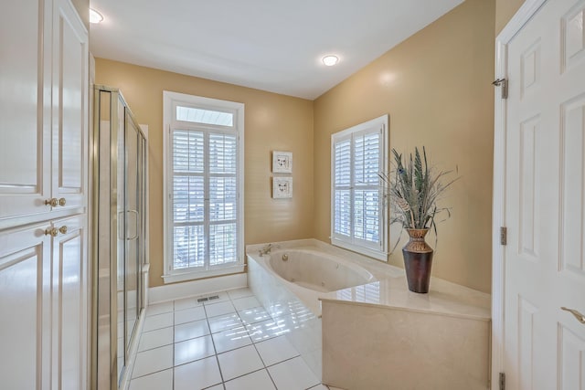 bathroom with tile patterned flooring and independent shower and bath