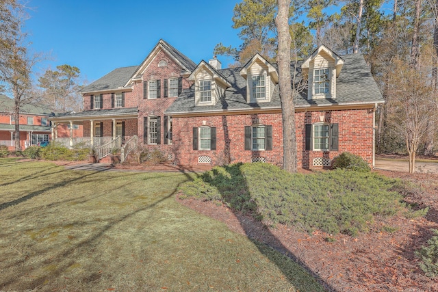 view of front facade featuring covered porch and a front yard