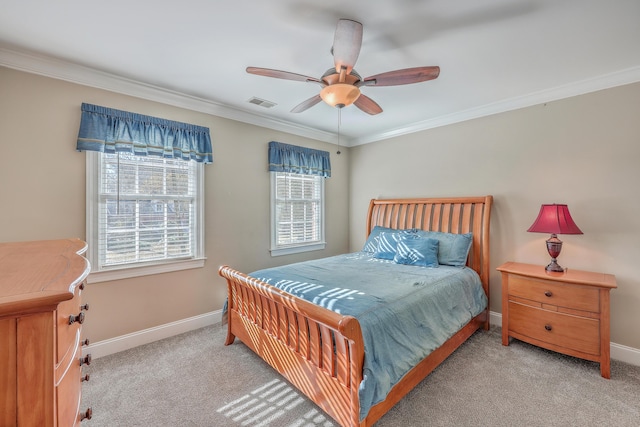 carpeted bedroom with ceiling fan and crown molding