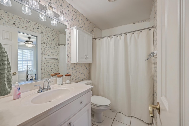 bathroom with tile patterned flooring, vanity, toilet, and ceiling fan