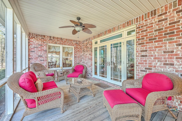 wooden deck featuring outdoor lounge area, ceiling fan, and french doors