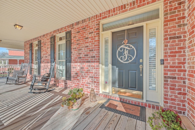 view of exterior entry with a porch