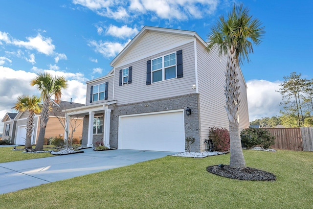 traditional-style home featuring concrete driveway, brick siding, fence, and a front lawn