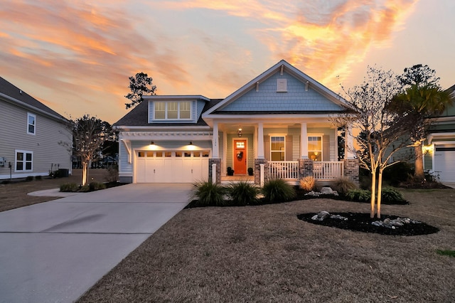 craftsman inspired home with a garage and covered porch