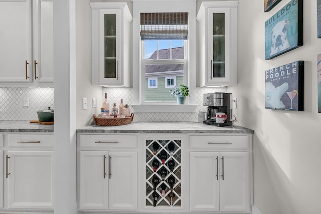 bar with white cabinetry, light stone counters, and wine cooler