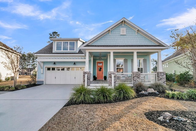 craftsman house with a porch and a garage