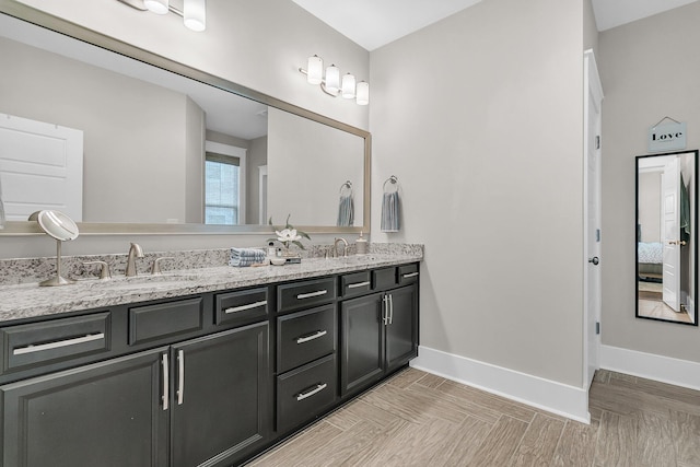 bathroom featuring parquet floors and vanity