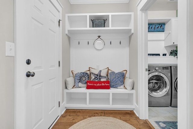 mudroom with hardwood / wood-style flooring and independent washer and dryer