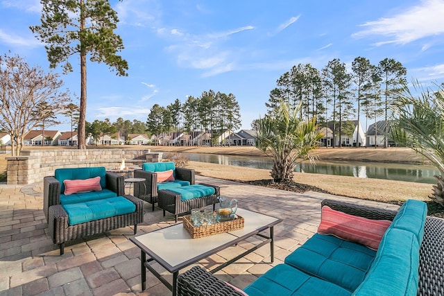 view of patio featuring outdoor lounge area and a water view