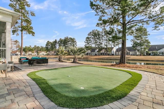 view of home's community featuring an outdoor living space, a water view, and a patio area