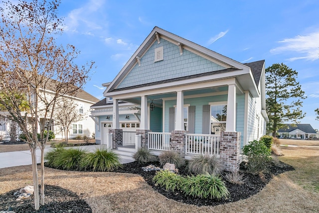 view of front of property featuring a garage and a porch