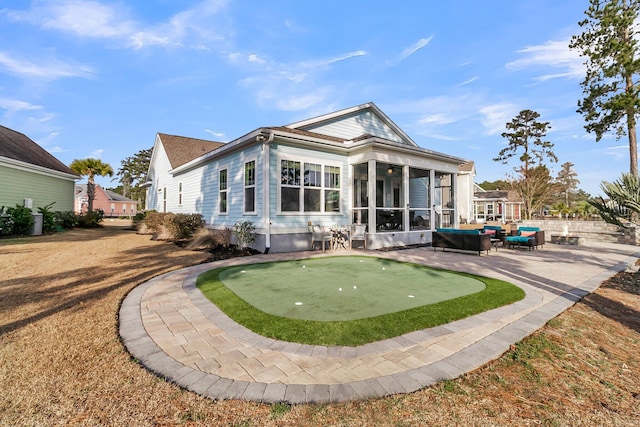 back of property featuring a patio and a sunroom