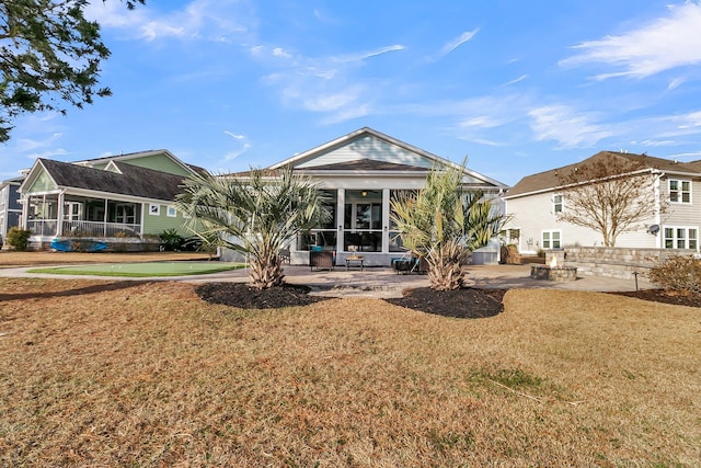 rear view of property with a patio and a yard