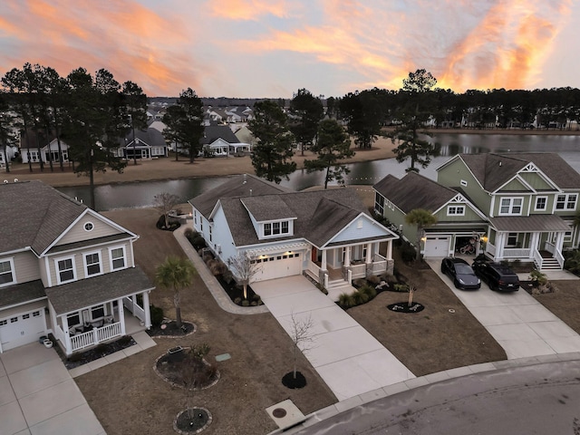 aerial view at dusk with a water view