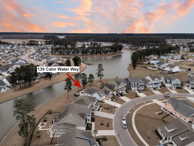 aerial view at dusk with a water view