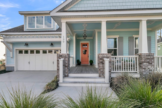 view of exterior entry with a garage and covered porch