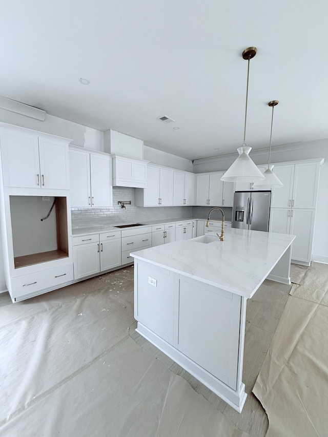 2790 Burden Creek Rd, Johns Island, SC 29455 - kitchen featuring stainless steel fridge with ice dispenser, a sink, a large island, white cabinets, and pendant lighting