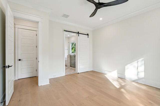 2790 Burden Creek Rd, Johns Island, SC 29455 - unfurnished bedroom with a barn door, light wood finished floors, baseboards, recessed lighting, and ornamental molding