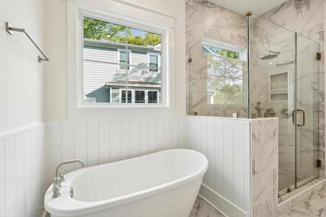 2790 Burden Creek Rd, Johns Island, SC 29455 - full bath featuring a freestanding tub, a marble finish shower, wainscoting, marble finish flooring, and a decorative wall