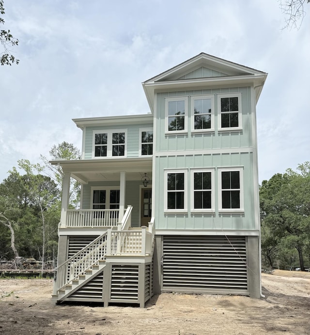 2790 Burden Creek Rd, Johns Island, SC 29455 - raised beach house featuring stairs, board and batten siding, and covered porch