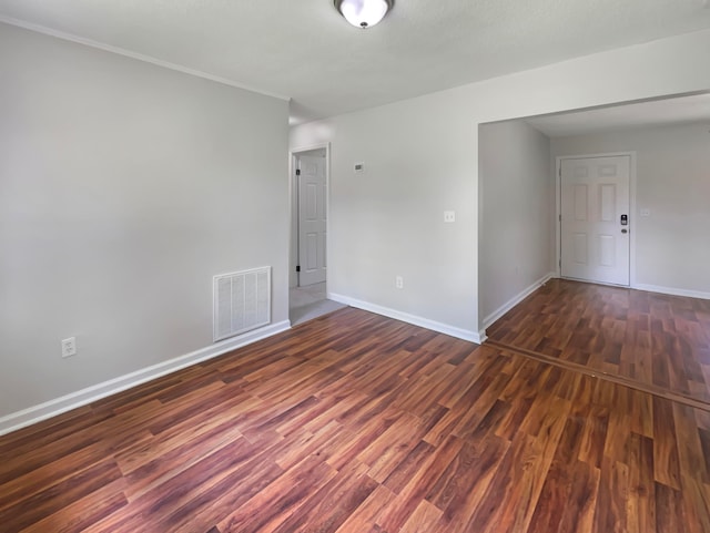 unfurnished room featuring dark wood-type flooring