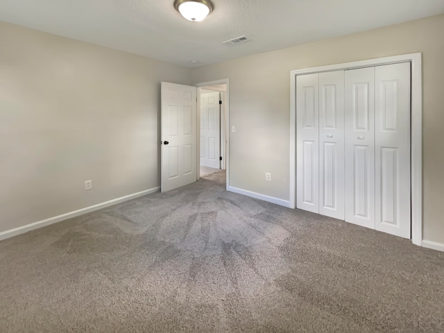 unfurnished bedroom featuring carpet floors and a closet