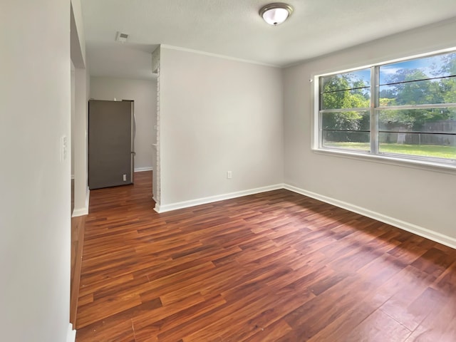 unfurnished room with dark wood-type flooring