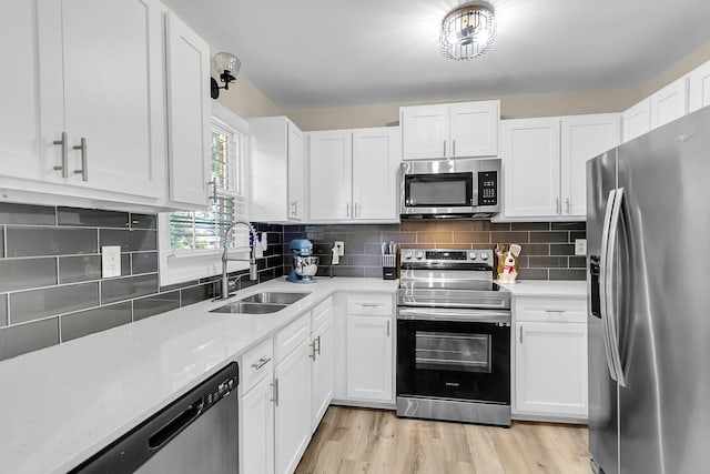 334 Water Oak Dr, Goose Creek, SC 29445 - kitchen featuring appliances with stainless steel finishes, a sink, white cabinets, light wood-style floors, and decorative backsplash