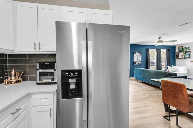 334 Water Oak Dr, Goose Creek, SC 29445 - kitchen with stainless steel fridge, tasteful backsplash, light wood-style flooring, and white cabinetry