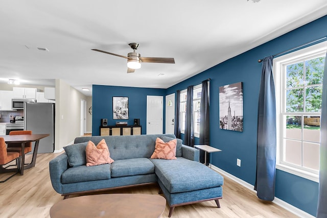 334 Water Oak Dr, Goose Creek, SC 29445 - living room with light wood-style floors, ceiling fan, and baseboards