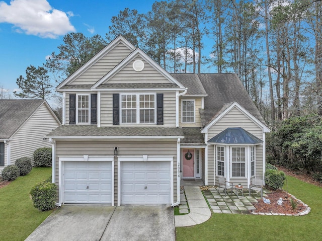 traditional-style house featuring driveway, a shingled roof, a front lawn, and an attached garage