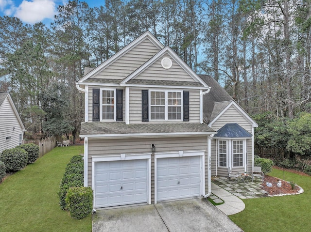 view of front of house featuring a garage, fence, a front lawn, and roof with shingles