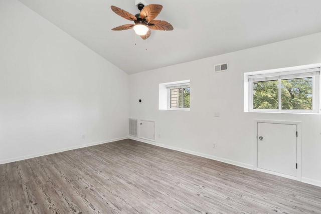 unfurnished room with light wood-type flooring, vaulted ceiling, ceiling fan, and baseboards