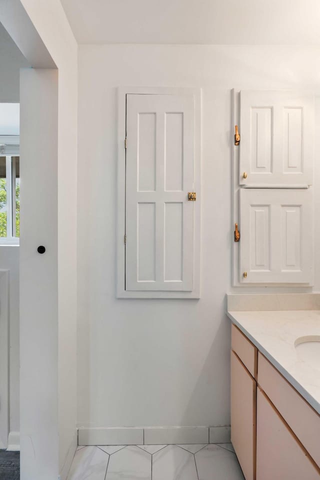 bathroom with baseboards and vanity