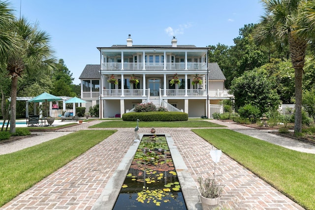 1972 Long Creek Rd, Wadmalaw Island, SC 29487 - exterior space featuring stairs, a porch, an outdoor pool, a balcony, and a lawn