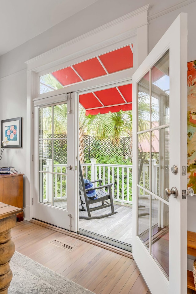 doorway to outside with french doors, visible vents, and hardwood / wood-style flooring