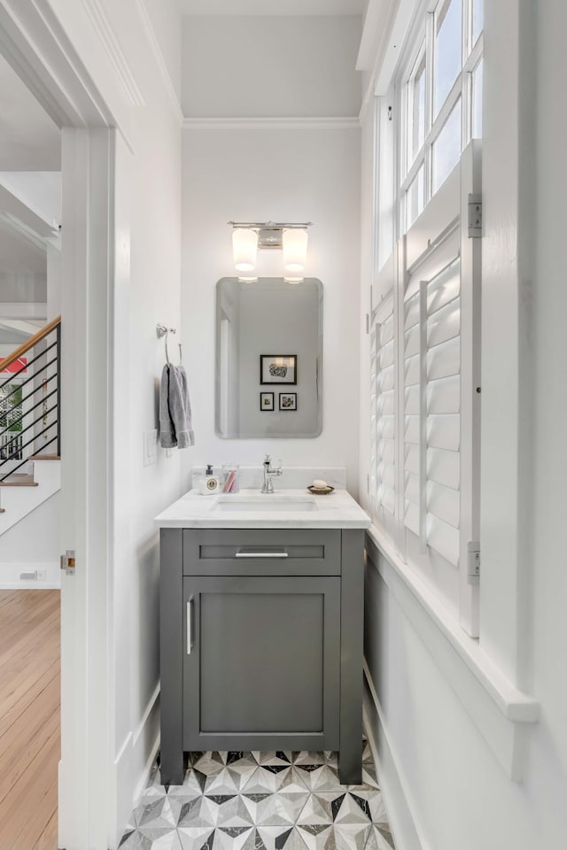 bathroom with tile patterned floors, vanity, and crown molding