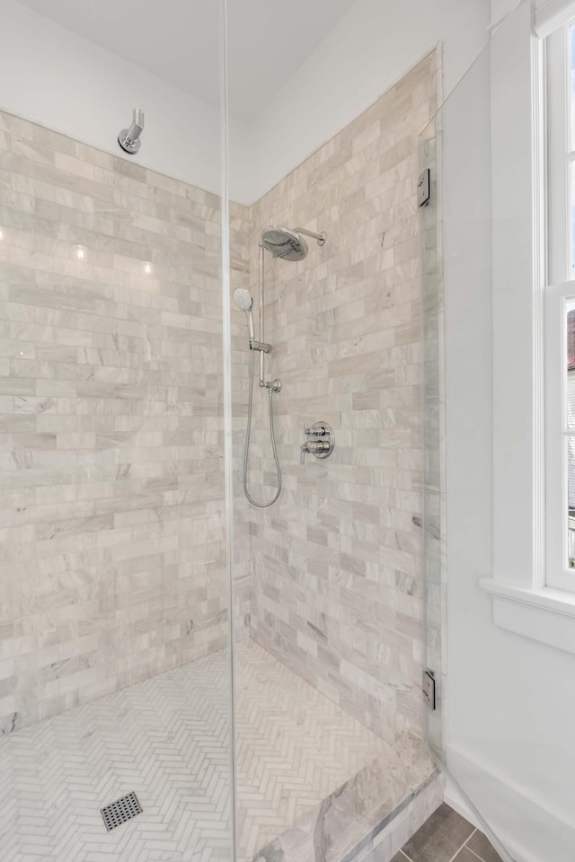 full bathroom featuring a shower stall and tile patterned flooring