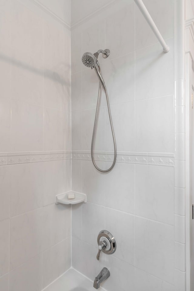 interior details featuring shower / bathing tub combination