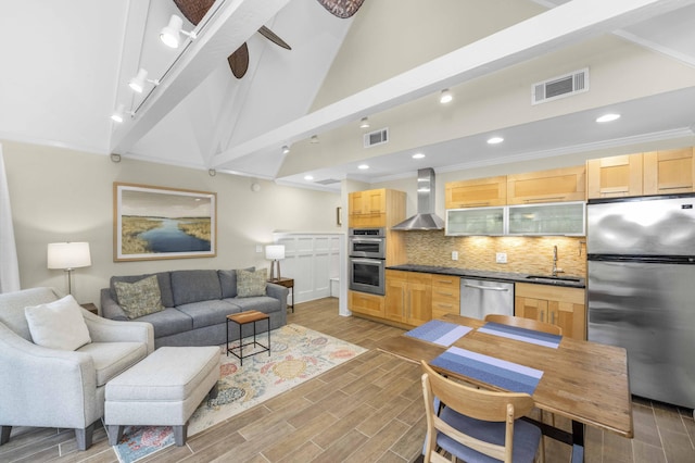 living room with ceiling fan, sink, lofted ceiling with beams, crown molding, and light wood-type flooring