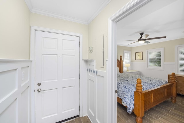 bedroom featuring hardwood / wood-style flooring, ceiling fan, and ornamental molding