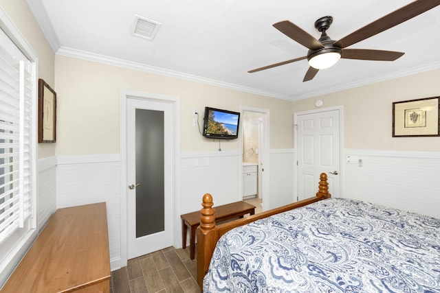 bedroom featuring connected bathroom, ceiling fan, crown molding, and dark wood-type flooring