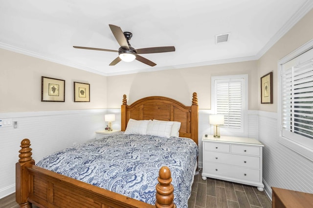 bedroom with ceiling fan, crown molding, and dark wood-type flooring