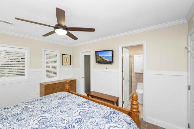 bedroom featuring ensuite bath, ceiling fan, and crown molding