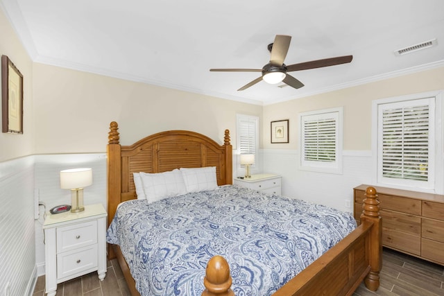 bedroom with ceiling fan, dark hardwood / wood-style floors, and ornamental molding