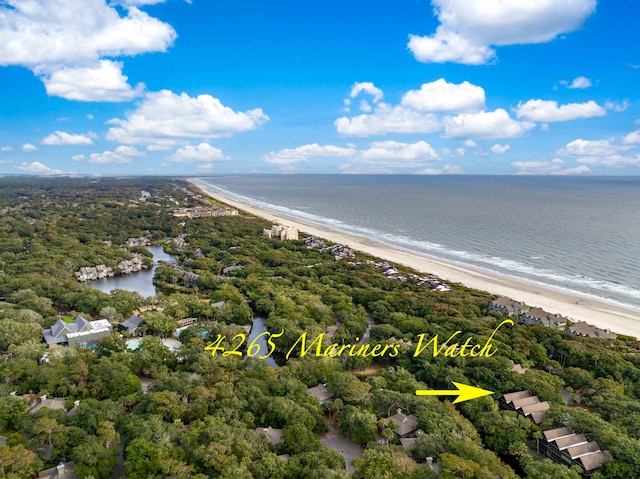 birds eye view of property with a water view and a beach view