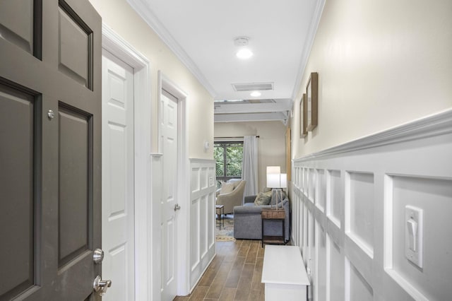 hallway with dark hardwood / wood-style flooring and crown molding