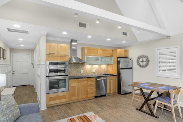 kitchen with lofted ceiling with beams, stainless steel appliances, wall chimney range hood, and light hardwood / wood-style floors