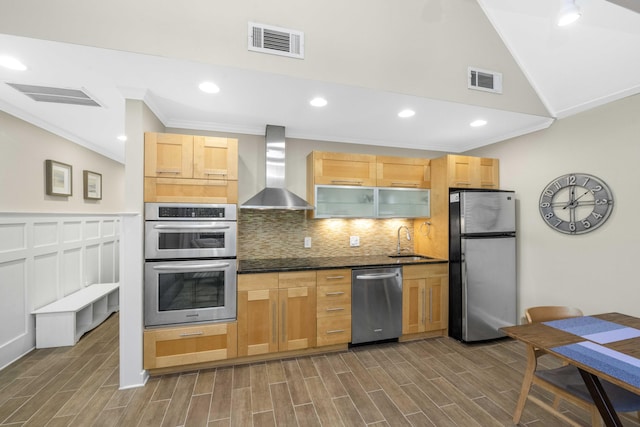 kitchen with wall chimney exhaust hood, sink, appliances with stainless steel finishes, and dark wood-type flooring